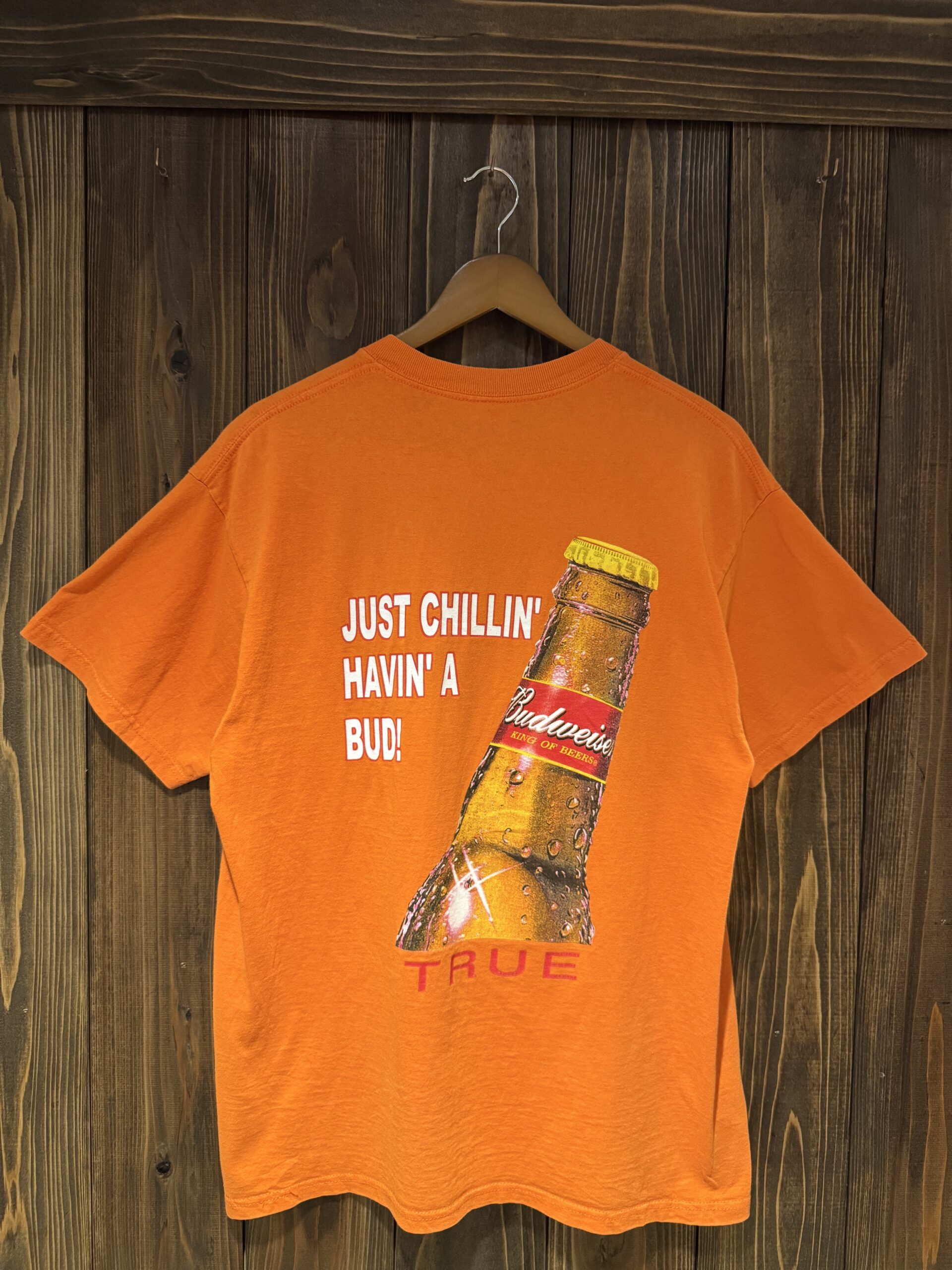 背中いっぱいにBudweiserビールボトルと「JUST CHILLIN' HAVIN' A BUD! TRUE」の文字がプリントされたバックデザインのハンガーショット。
